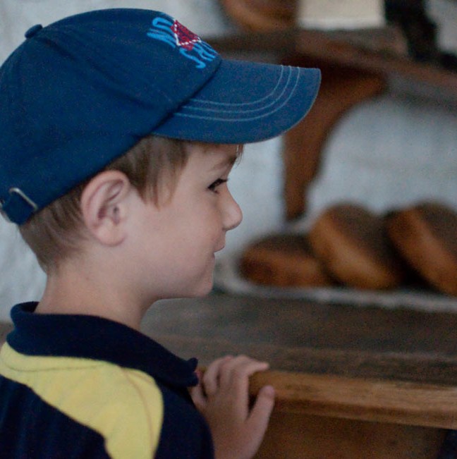 6 year-old Will salivates over the freshly-baked bread in Fort Henry’s original bakery.