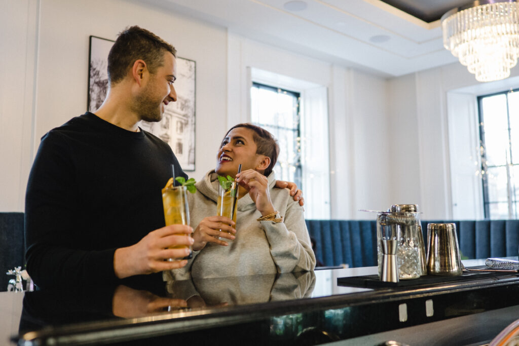 Two people at the Frontenac Club in the bar with drinks