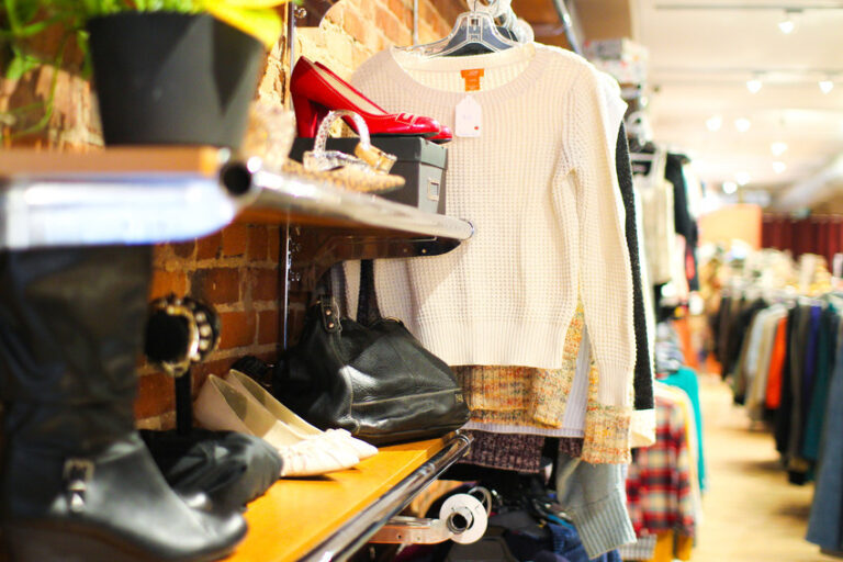 photo of interior of YGK thrift with shoe shelves and colourful clothing racks