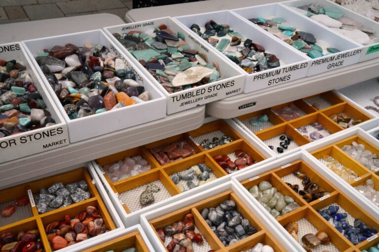 shiny rocks of all sorts shapes and colours line the Rox Rock Shop market stall booth's displays