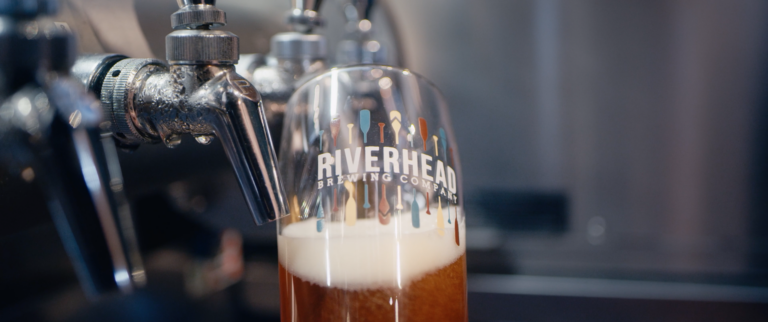 A pint of Riverhead beer pored from a tap