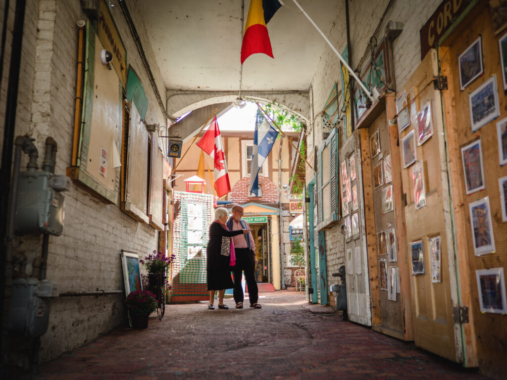 Two people looking at art in Martello Alley