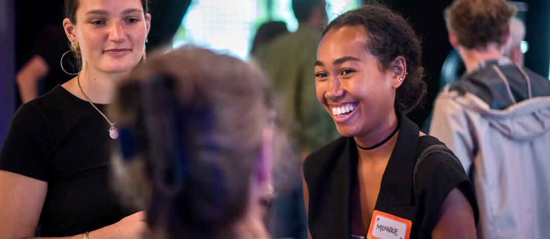 Three people engaged in conversation at Makers Meetup