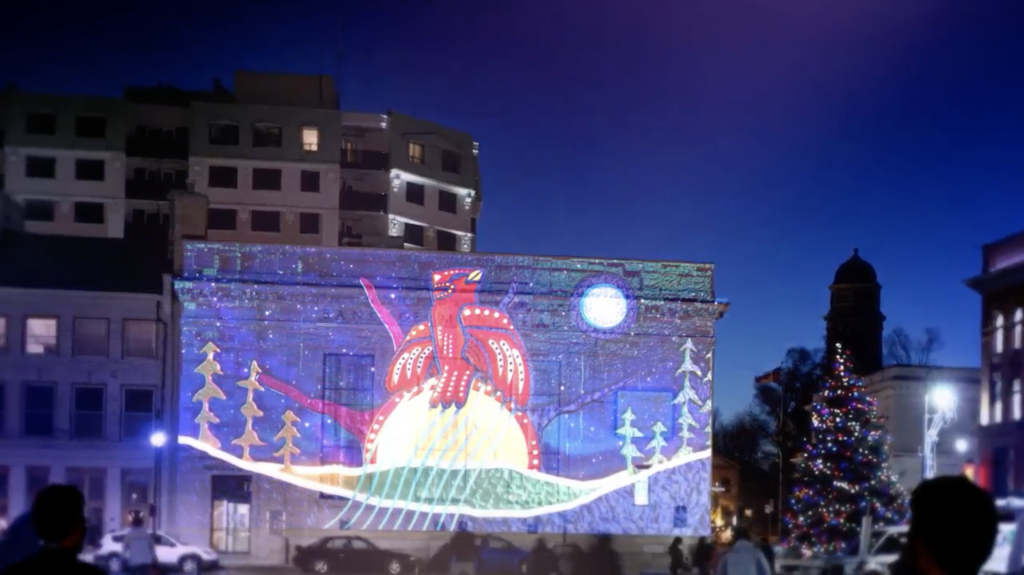 Cardinal’s painting projected onto a building